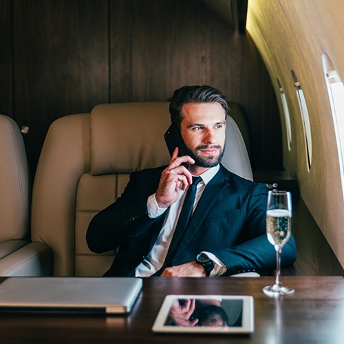 Business man on phone in corporate jet