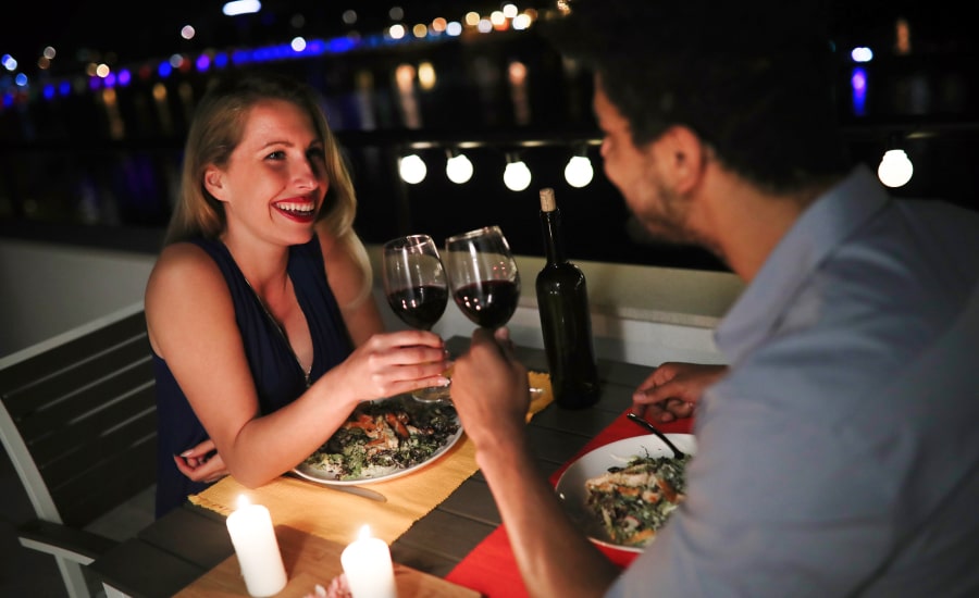 Couple on a river cruise having dinner and wine