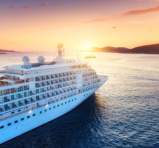 Cruise ship cruising towards the sunset